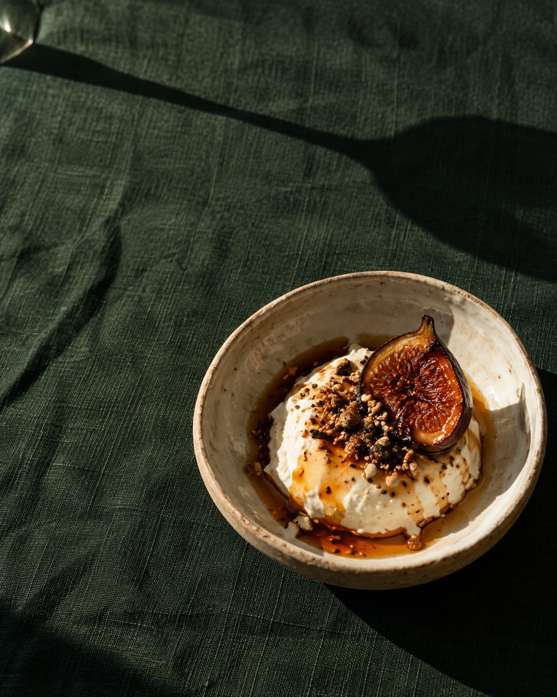 Set curd in a small bowl with burnt honey and a smoked fig